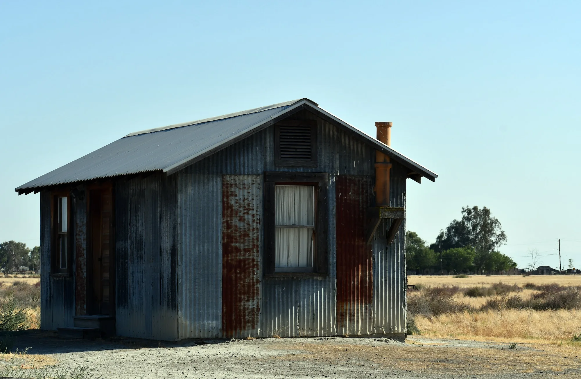 metal old rusty hut in the middle of a dry field on a sunny day 2