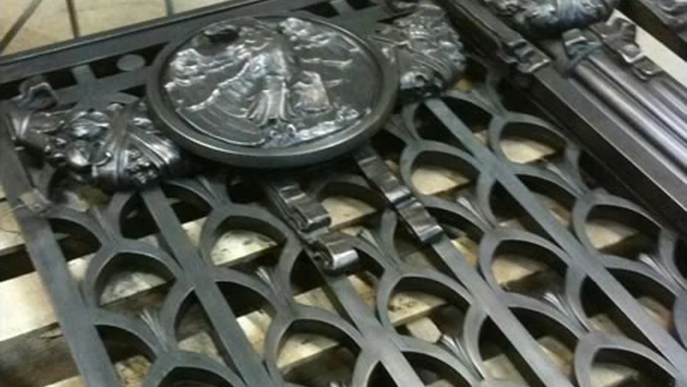 Ornamental bronze gate from the Alexander Hamilton U.S. Custom House on the bench during shop restoration