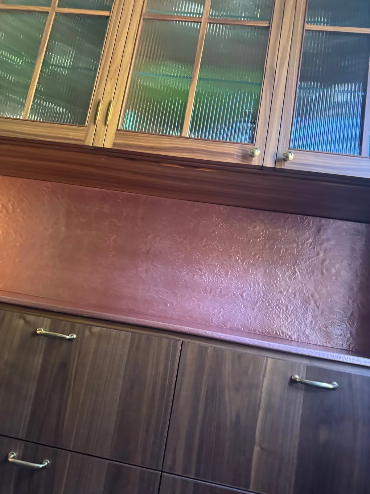 Copper bar top and backsplash restored to an even, warm finish after polishing